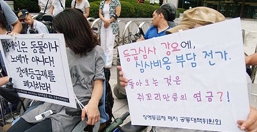복지부가 지난해 사회복지공동모금회의 지원을 받아 진행했던 '장애인연금신청용 장애진단비용 지원사업'이 예산의 2%만 사용된 채 마무리됐다. 사진은 장애인들이 장애등급심사에 반대하며 플랜카드를 들고 있는 모습. ⓒ에이블뉴스